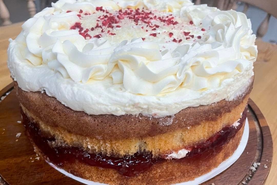 A Victoria sponge with cream and jam