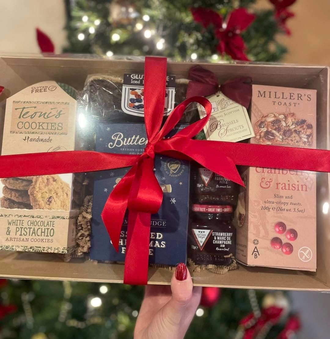 A Christmas hamper tied with a red ribbon