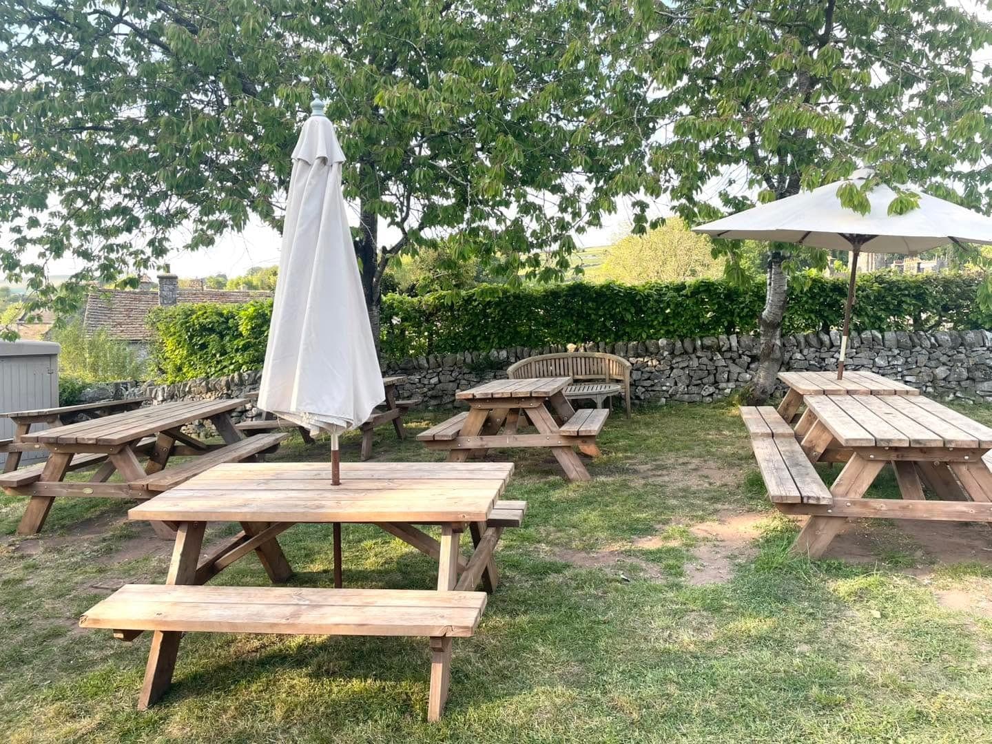 Picnic benches and a parasol in the outdoor seating area