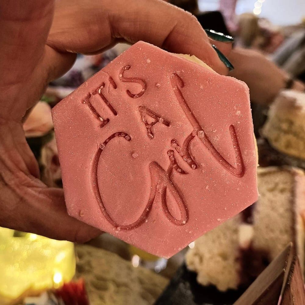 A pink It's a Girl biscuit from a baby shower afternoon tea