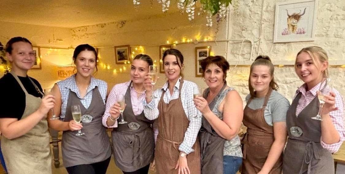 The team raising a glass together in the café